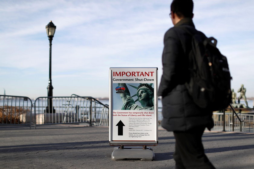 A sign announcing the closure of the Statue of Liberty, due to the U.S. government shutdown, sits ne