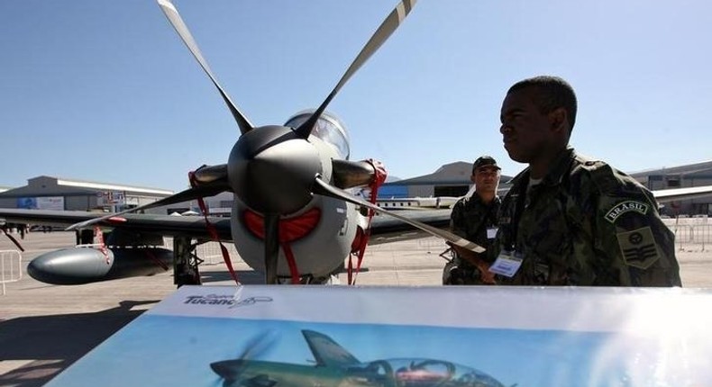 A Brazilian soldier stands guard near a A-29 Super Tucano during the opening ceremony of the Santiago's Aviation Fair, known as FIDAE, at Chile's international airport, file. 