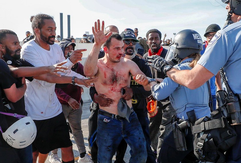 Protesters scale a truck that was driven into a rally