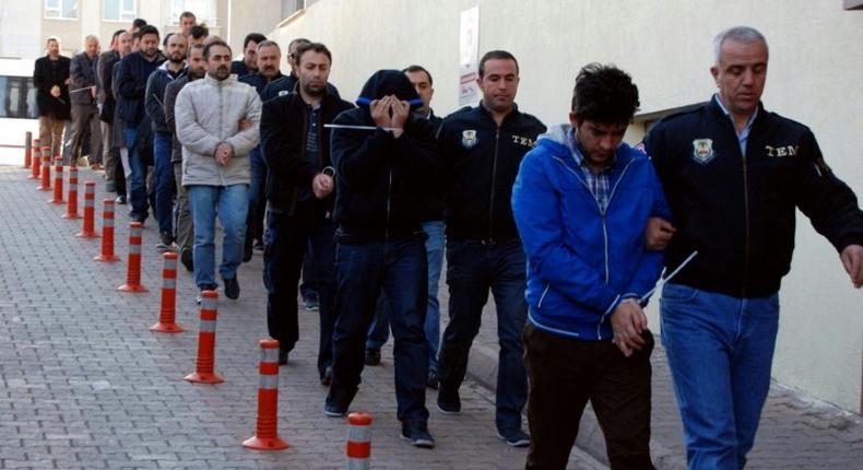 Turkish police escort people after their arrest for alleged links with US-based Muslim cleric Fethullah Gulen on April 26, 2017 in the central city of Kayseri