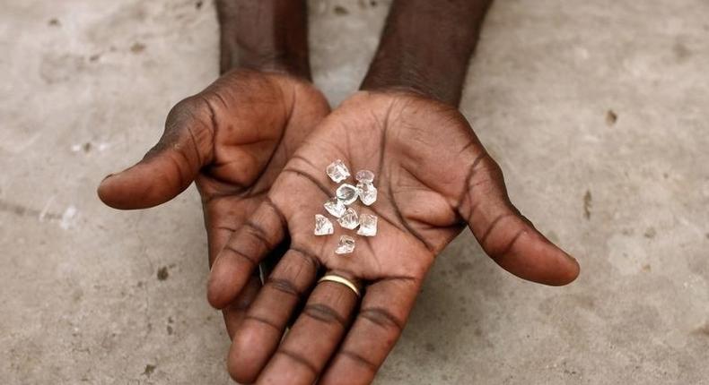 A diamond dealer from Zimbabwe displays diamonds for sale in Manica, near the border with Zimbabwe, September 19, 2010. REUTERS/Goran Tomasevic