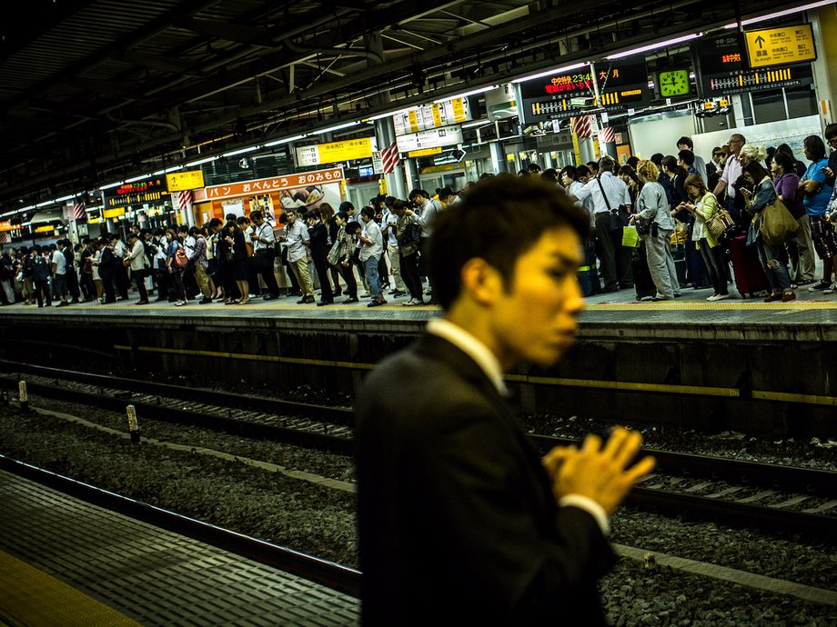 Commuters line up for one of the last trains of the day at Tokyo's Shinjuku station.