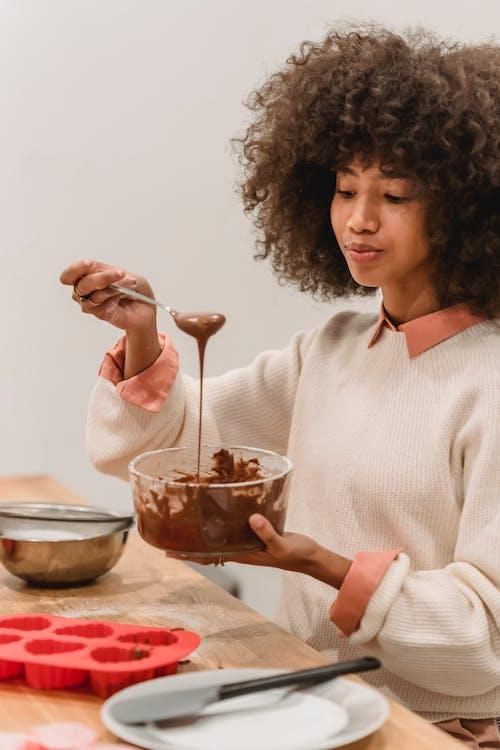 Lady mixing melted chocolate