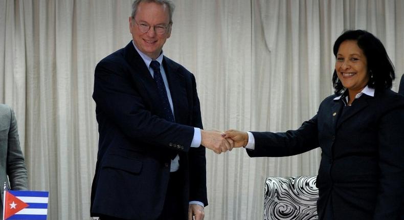 Google Executive Chairman Eric Schmidt (L) and Cuban national telecom provider (ETECSA) president executive Mayra Arevich shake hands after the signing of a bilateral agreement in Havana, on December 12, 2016