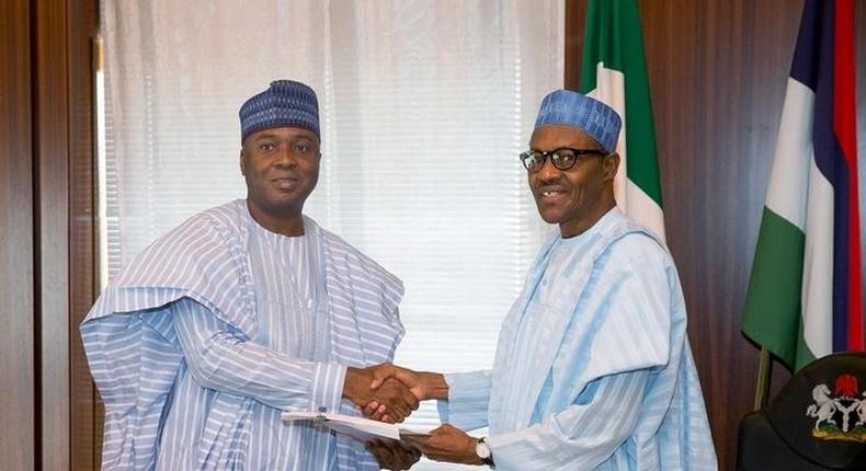 Nigeria's President Muhammadu Buhari (R) receive a letter of confirmation from the President of the Senate of Nigeria Bukola Saraki in Abuja, Nigeria, November 3, 2015. REUTERS/Stringer