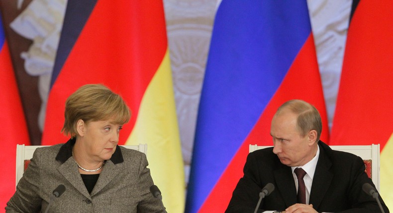 Russian President Vladimir Putin, right, with German Chancellor Angela Merkel during a joint news conference in Moscow's Kremlin on Nov.16, 2012.