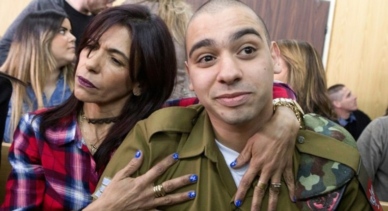 Israeli soldier Elor Azaria is embraced by his mother at the start of his sentencing hearing in a military court in Tel Aviv, on February 21, 2017