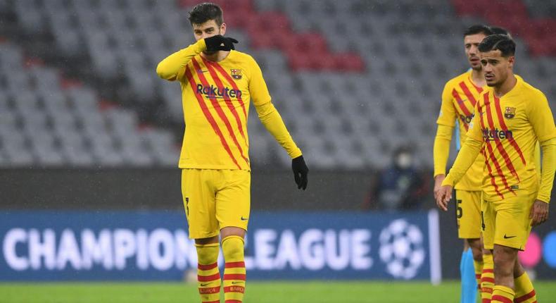 Gerard Pique (L) and Philippe Coutinho at the end of Barcelona's 3-0 defeat at the hands of Bayern Munich that sent them packing from the Champions League