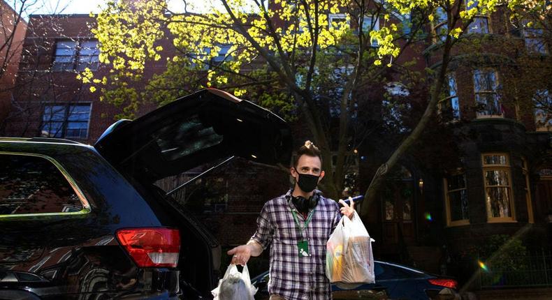 Instacart shopper, makes a grocery delivery during the coronavirus pandemic in Washington, DC, April 6, 2020.