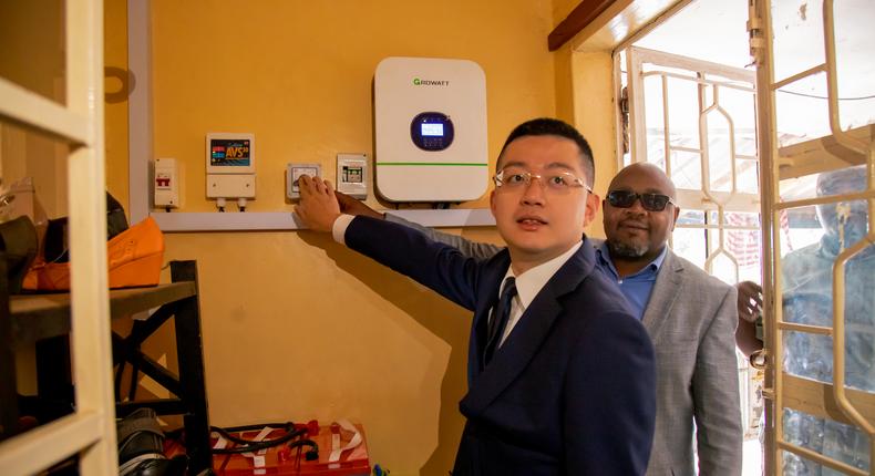  Mr. Ma Chengyuan, Chief Representative of AVIC International Holding Corporation in Kenya accompanied by Mutuini MCA Mr. Martin Mbugua switch on the solar system at at Shiphrah Children Centre in Mutuini Ward, Dagoretti South constituency in Nairobi.