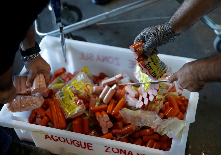 Members of the Public Health Surveillance Agency collect sausages to analyse in their laboratory, at a supermarket in Rio de Janeiro, Brazil, March 20, 2017.