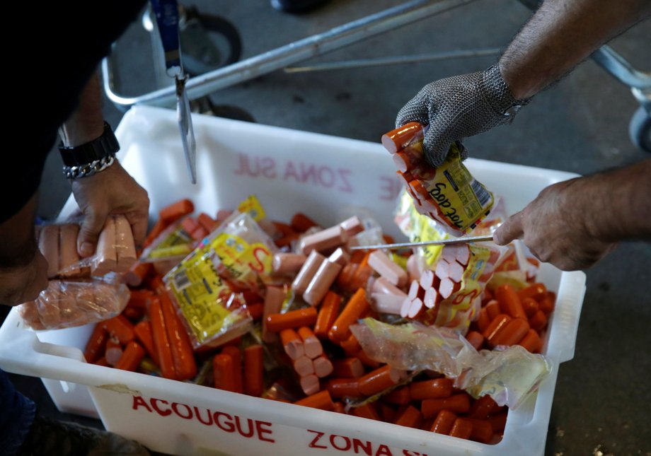 Members of the Public Health Surveillance Agency collect sausages to analyse in their laboratory, at a supermarket in Rio de Janeiro, Brazil, March 20, 2017.