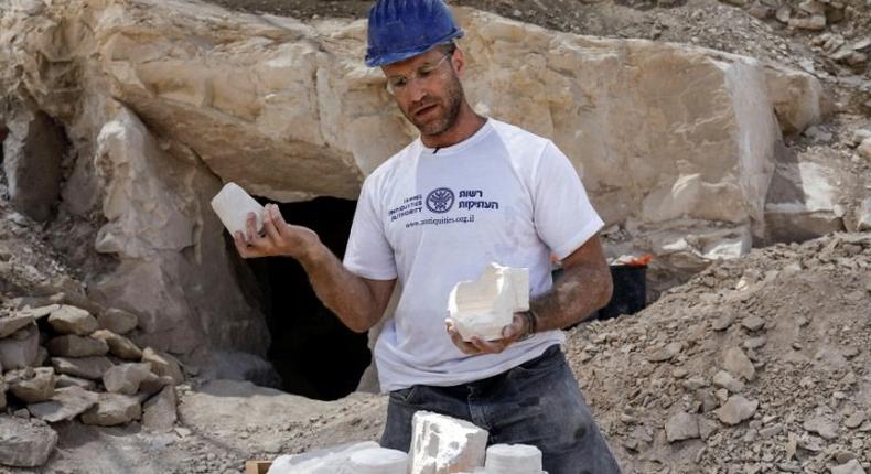 Archaeologist Yonatan Adler displays chalkstone mugs and cores on August 10, 2017, two months after they were discovered near the Israeli village of Reina, close to Cana