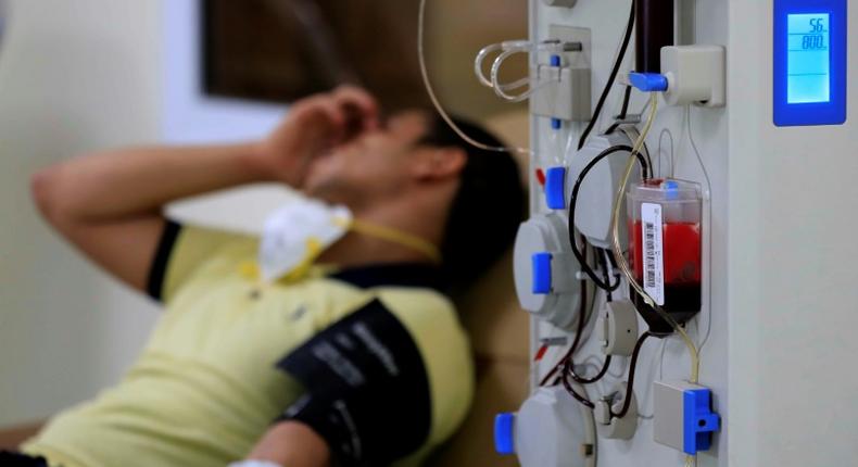 An Egyptian man who recovered from Covid-19 donates blood at the National Blood Transfusion centre in Cairo