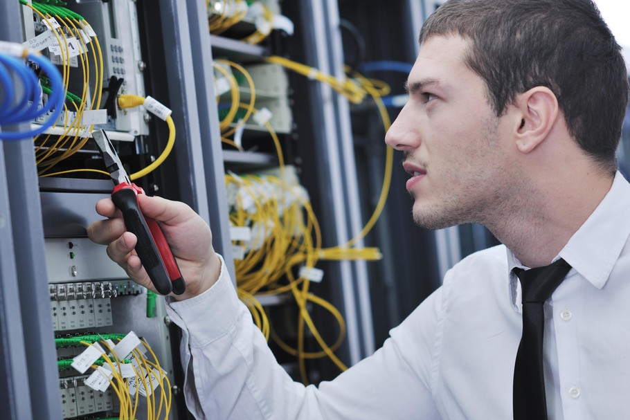 young engeneer in datacenter server room