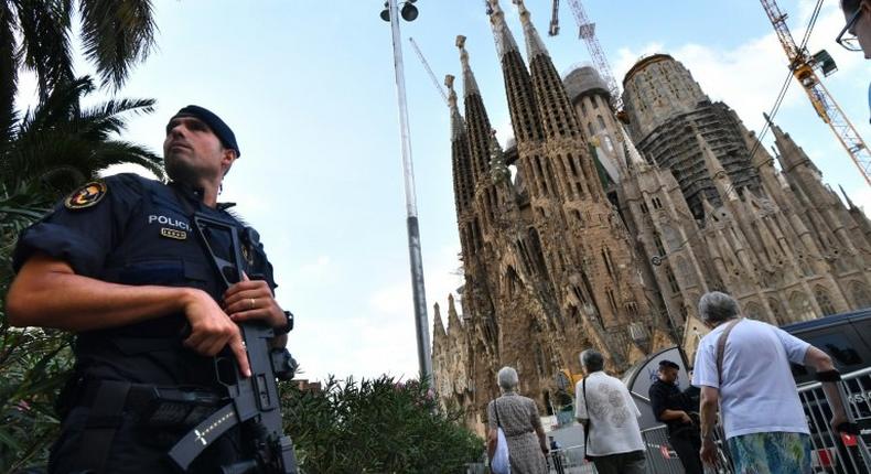 A police officer stands by the Sagrada Familia basilica in Barcelona