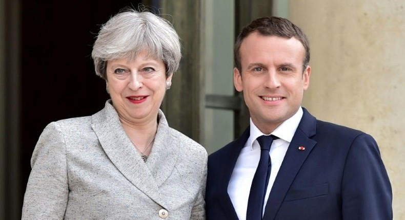 Britain's Prime Minister Theresa May (L) is greeted by France's President Emmanuel Macron ahead of a meeting at The Elysee Palace in Paris on June 13, 2017