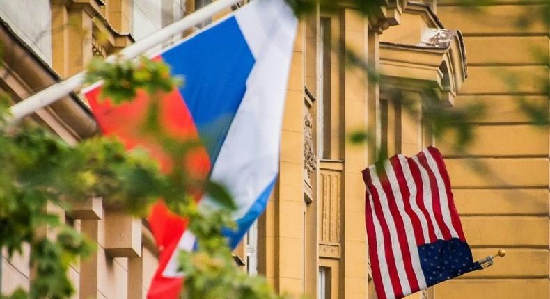 A Russian flag flies next to the US embassy building in Moscow on July 31, 2017