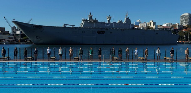 Australia's naval ship HMAS Canberra forms a backdrop as Sydney's Andrew Boy Charlton swimming poo