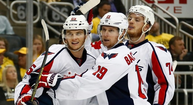 Andre Burakovsky (L) celebrates scoring against the Pittsburgh Penguins as the Washington Capitals win 5-2