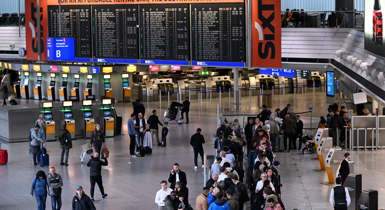 Passengers lining up at Frankfurt Airport.KIRILL KUDRYAVTSEV/AFP via Getty Images