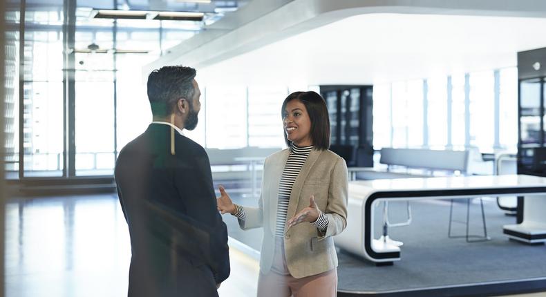 woman talking to man at work