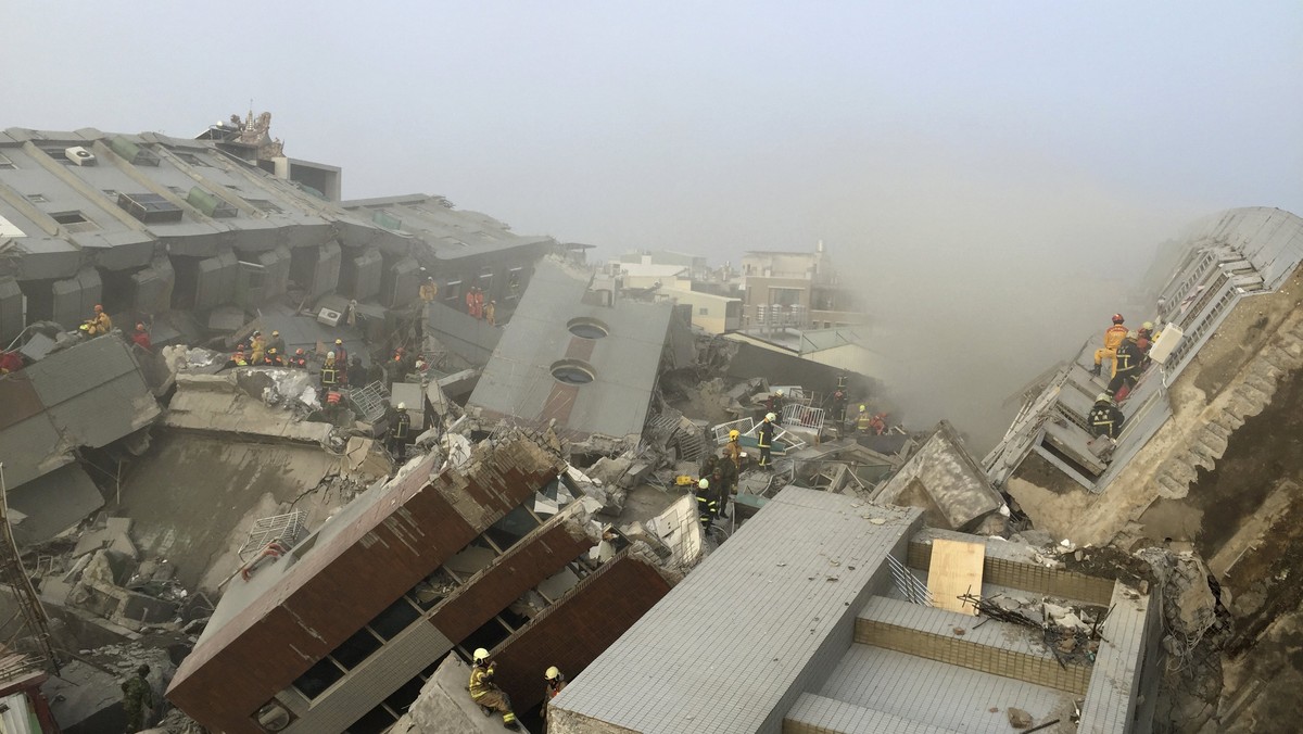 Rescue personnel work at the site where a 17-storey apartment building collapsed, after an earthquake in Tainan