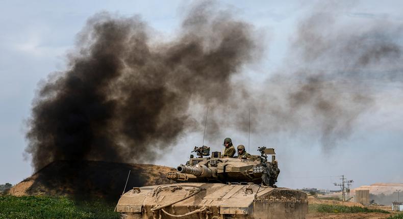 Israeli soldiers drive an tanks on the border with the Gaza Strip, in southern Israel on Feb. 13, 2024.AP Photo/Ariel Schalit