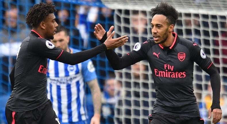 Arsenal's Gabonese striker Pierre-Emerick Aubameyang (R) celebrates with Arsenal's Nigerian striker Alex Iwobi after scoring their first goal during the English Premier League football match between Brighton and Hove Albion and Arsenal at the American Express Community Stadium in Brighton, southern England on March 4, 2018.