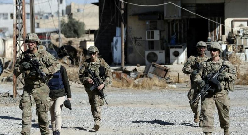 US soldiers patrol near an Iraqi army base on the outskirts of Mosul, on November 23, 2016