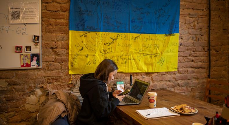 A woman works on a laptop in one of the rooms of the center for the arrival of Ukrainian refugees on March 4, 2022, in western Ukraine.