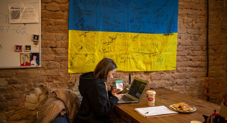 A woman works on a laptop in one of the rooms of the center for the arrival of Ukrainian refugees on March 4, 2022, in western Ukraine.