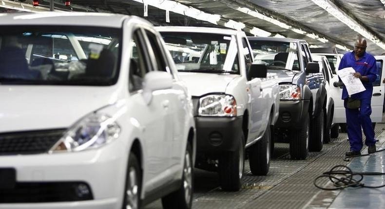 A worker inspects cars at Nissan's manufacturing plant in Rosslyn, outside Pretoria, in a file photo. 