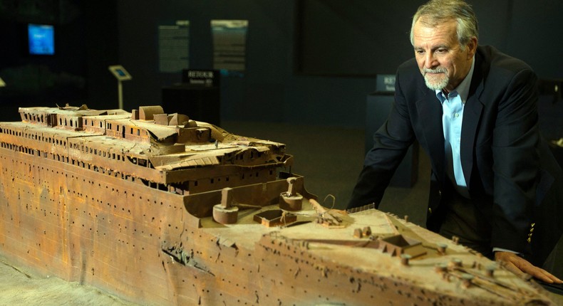 Paul-Henri Nargeolet, director of a deep ocean research project dedicated to the Titanic, poses next to a miniature version of the sunken ship inside a new exhibition, at 'Paris Expo', on May 31, 2013, in Paris.Jol SAGET / AFP