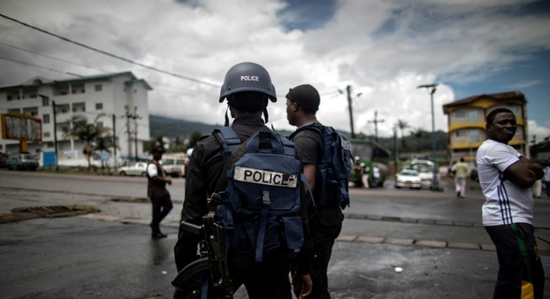 Policemen patrol the market in Buea in the majority English-speaking Southwest Region of Cameroon on October 3, 2018