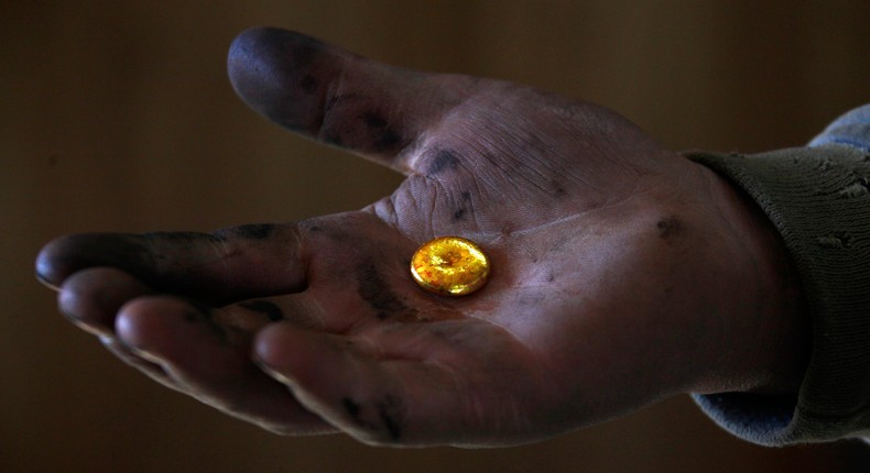 A small-scale miner holds his gold that was melted together at a processing plant located around 100km (62 miles) north of the Mongolian capital city Ulan Bator April 5, 2012. REUTERS/David Gray