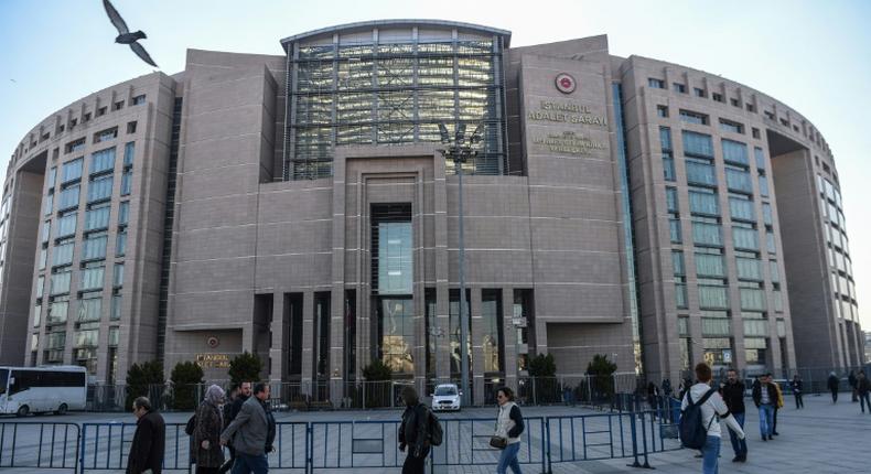 Turkish police escorted Topuz into the Caglayan courthouse in Istanbul, where he faces life in jail if found guilty