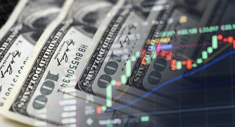 Cash dollars and stock market indicators (inflation, economy, crisis, finance)Getty Images