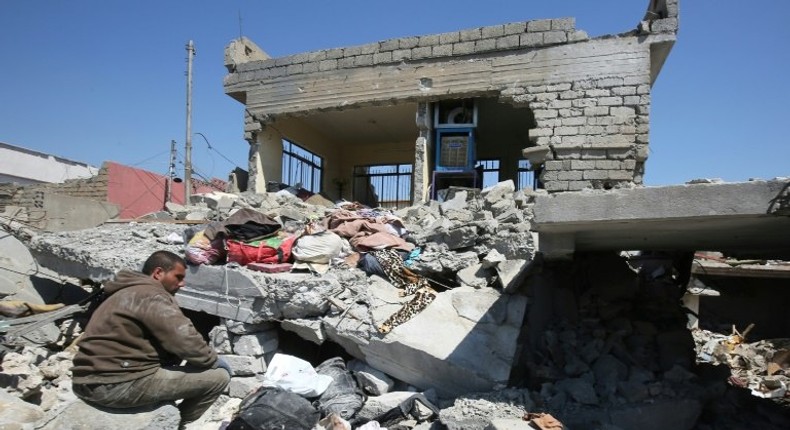 An Iraqi man in the rubble of destroyed houses in Mosul's al-Jadida area on March 26, 2017, after air strikes which reportedly killed civilians