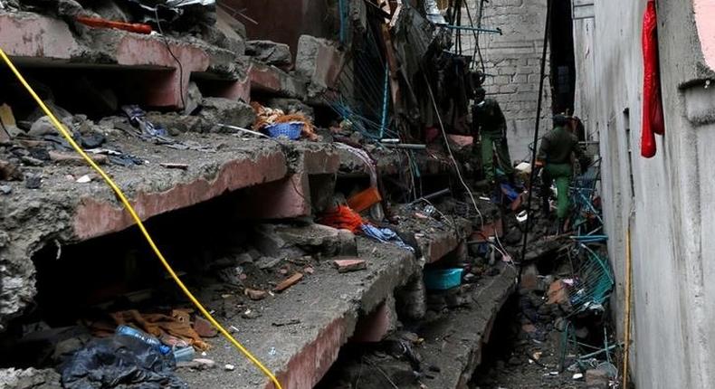 Rescue workers search for residents feared trapped in the rubble of a six-storey building that collapsed after days of heavy rain in Nairobi, Kenya, May 1, 2016. 