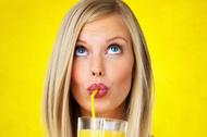 Thoughtful woman sipping orange juice