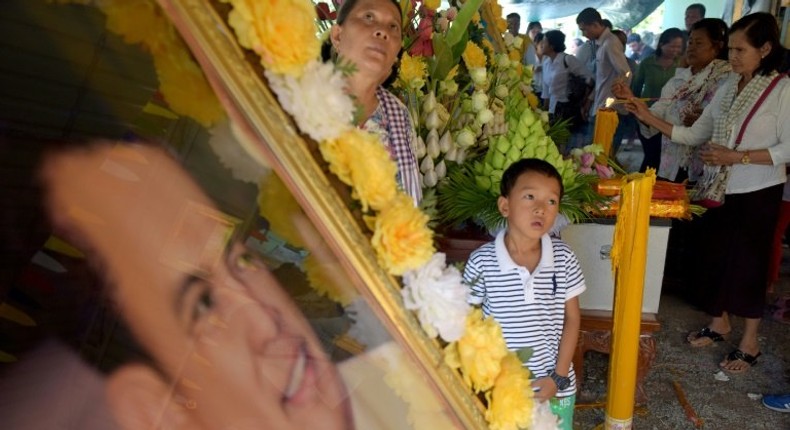 Thousands gathered on Sunday at the grave of prominent Cambodian critic Kem Ley who was gunned down a year ago in a murder that sparked widespread anger and scepticism over the alleged killer's motives.