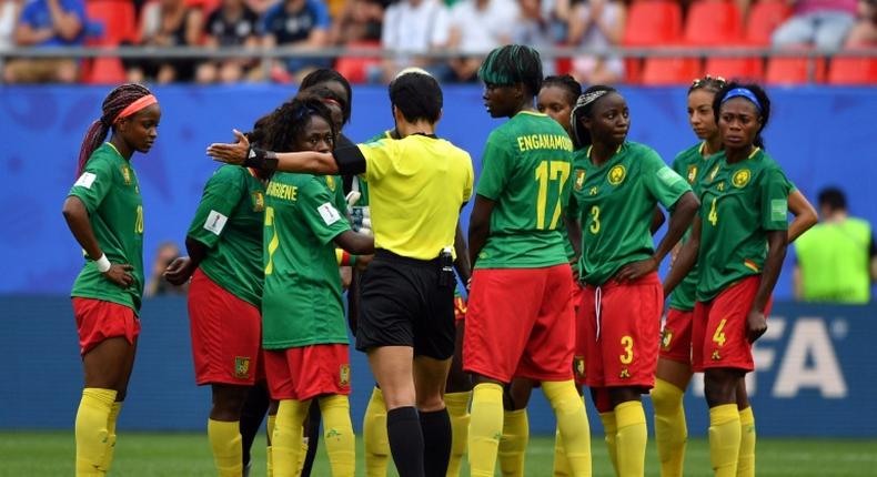 Chinese referee Qin Liang awards one of the goals much to the dismay of the Cameroon team