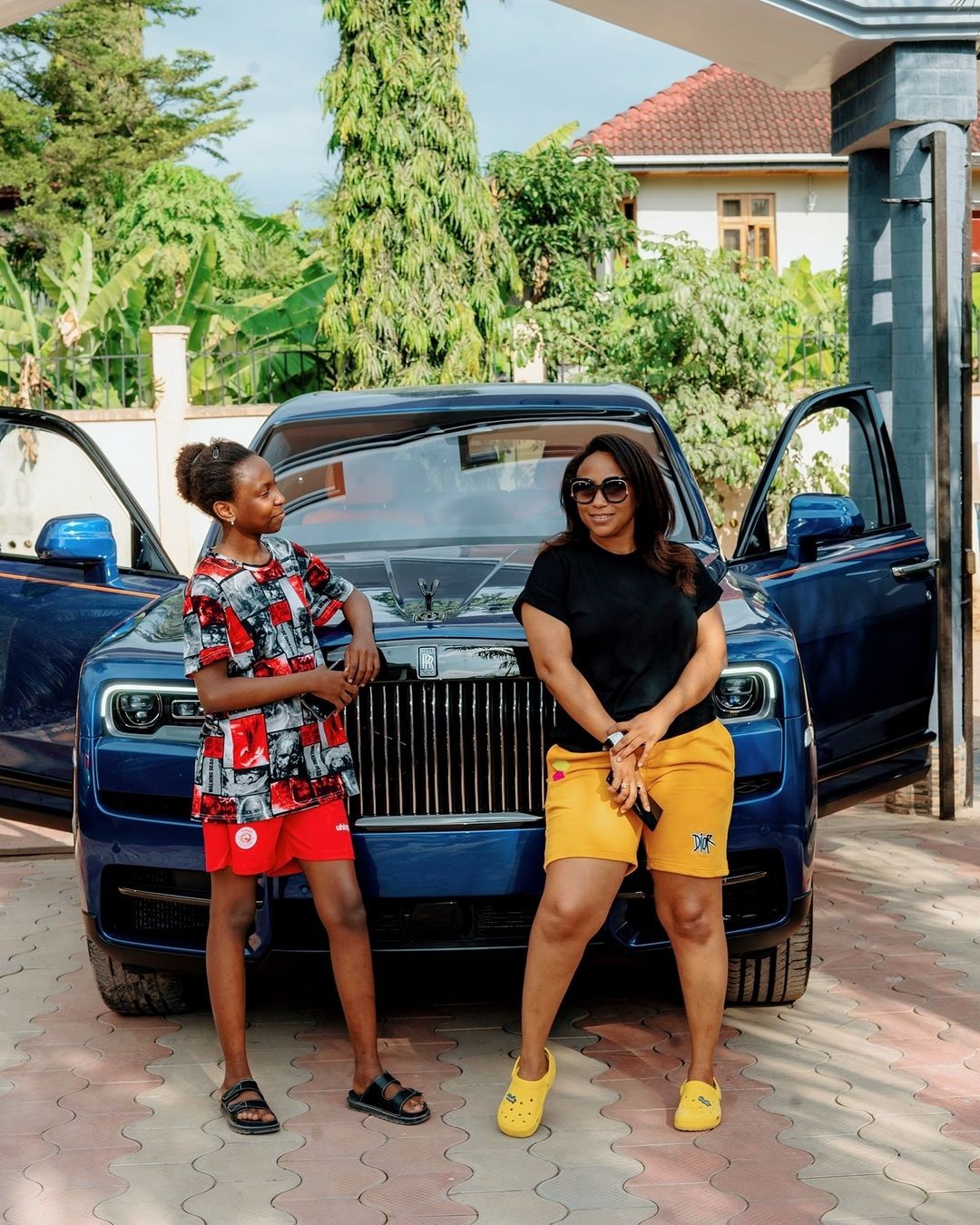 Diamond's sister Esma in front of The 2021 Rolls-Royce Cullinan