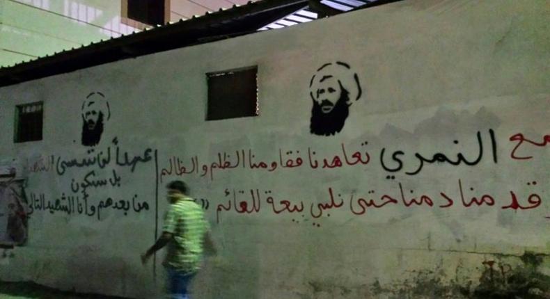 A man walks past images of executed Shiite cleric Nimr al-Nimr on a wall in the Awamiya area in Saudi Arabia's Eastern province, in a picture taken in 2016