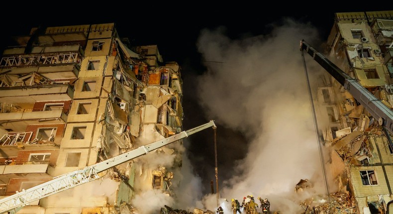 Emergency personnel work at the site where an apartment block was heavily damaged by a Russian missile strike, amid Russia's attack on Ukraine, in Dnipro, Ukraine January 15, 2023.REUTERS