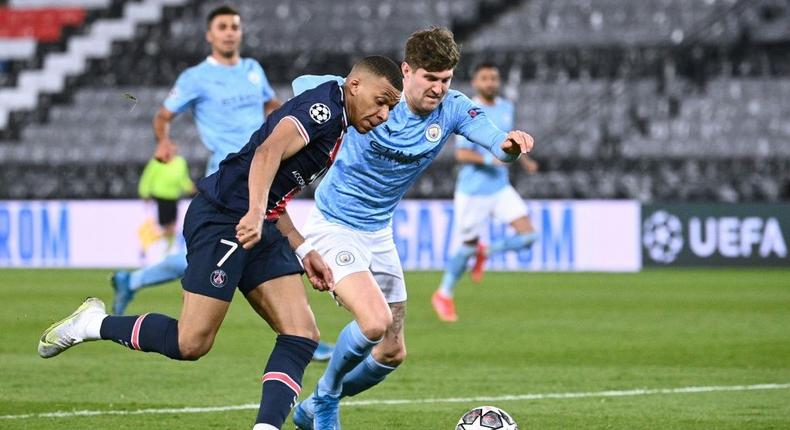 John Stones (right) helped keep PSG star duo Kylian Mbappe (left) and Neymar quiet