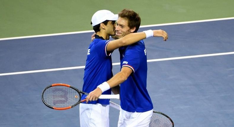 France's Pierre-Hugues Herbert (L) and Nicolas Mahut celebrate their their victory over Japan in the Davis Cup first round on February 4, 2017