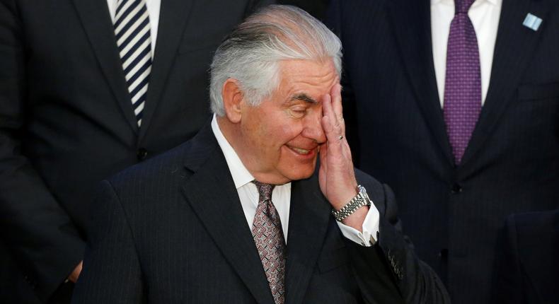 Secretary of State Rex Tillerson wipes his face during the delegation photo with leaders from Global Coalition working to Defeat ISIS at the State Department in Washington, U.S., March 22, 2017.