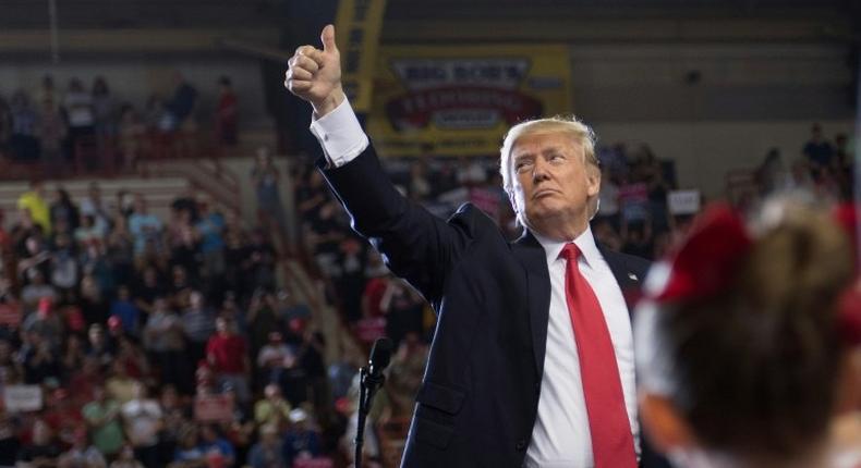 At an enthusiastic, campaign-style rally in Pennsylvania, US President Donald Trump (C) said the record of his first 100 days has been very exciting and very productive